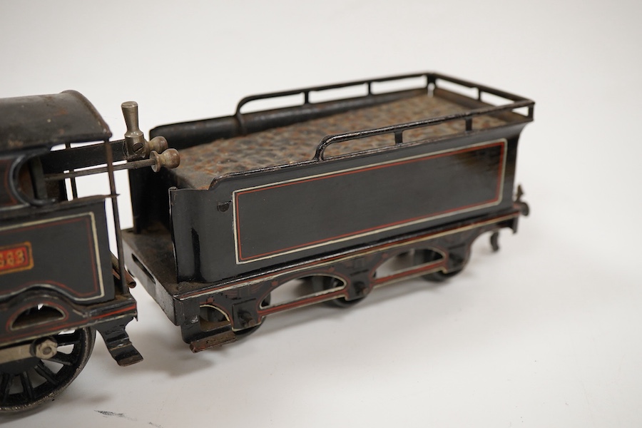 An 0 gauge Bing for Bassett-Lowke tinplate clockwork LNWR 4-4-0 tender locomotive, George the Fifth 2663, in red lined black livery with original clockwork mechanism